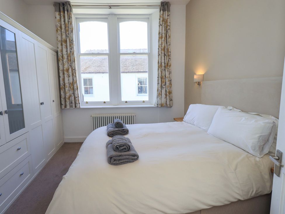 A bedroom with a bed and wardrobe at St Johns View in Keswick