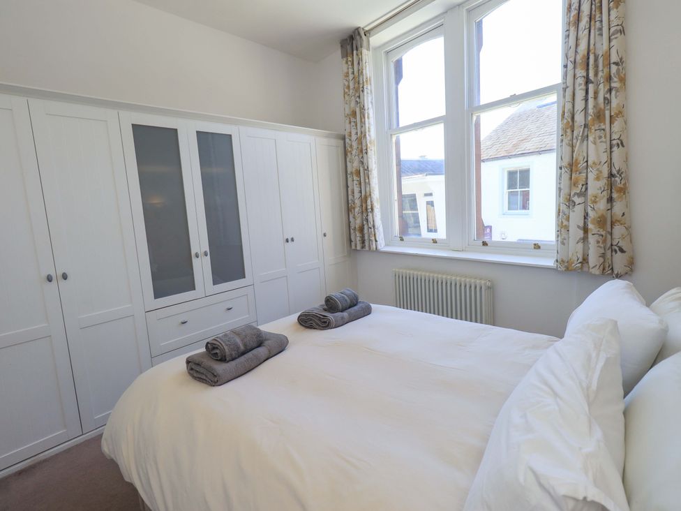 A bedroom with a bed and wardrobe at St Johns View in Keswick