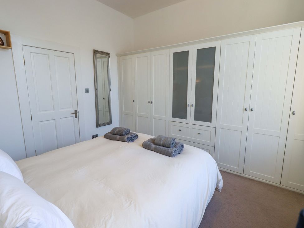 A bedroom with a bed and wardrobe at St Johns View in Keswick