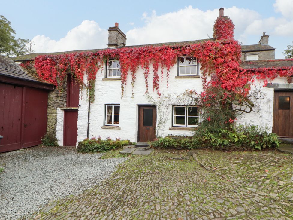A house with ivy on the walls at Mill Cottage Garnett Bridge