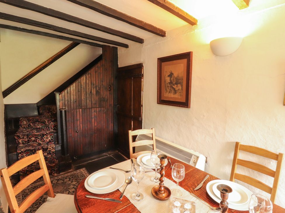 A dining room with a table set for a meal at Mill Cottage in Garnett Bridge