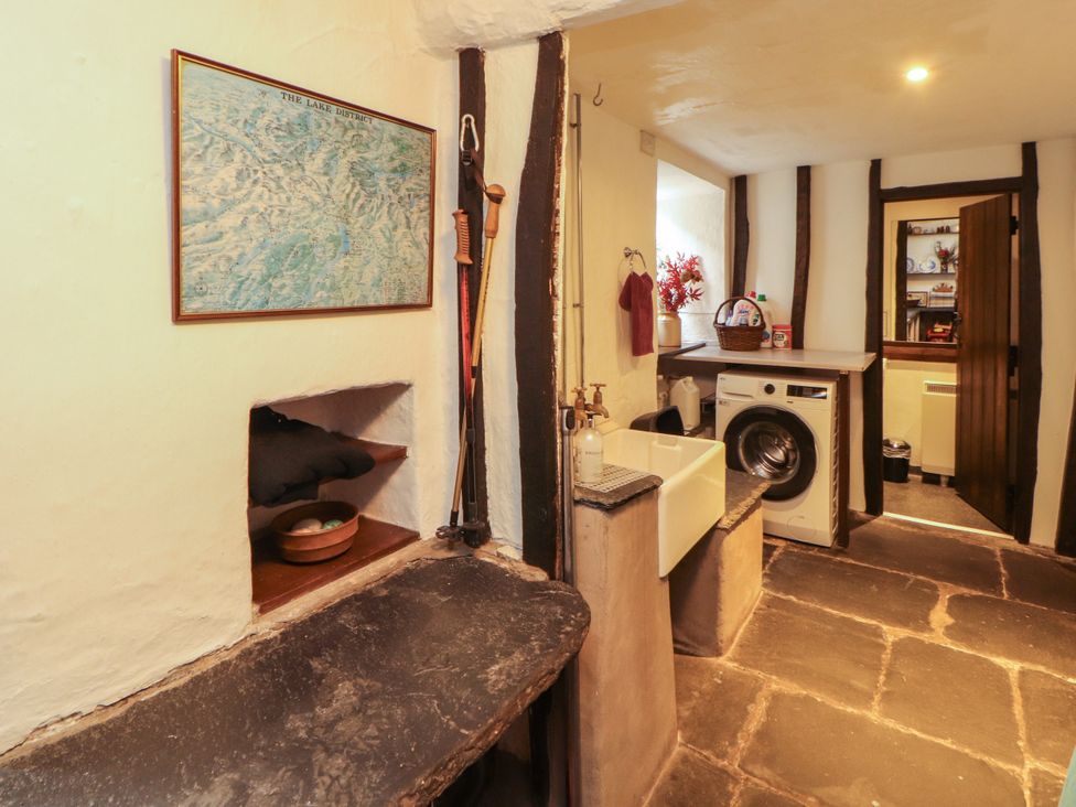 A laundry room with a sink and washing machine at Mill Cottage Garnett Bridge