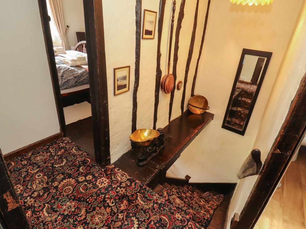 A staircase with wooden features and decor at Mill Cottage Garnett Bridge