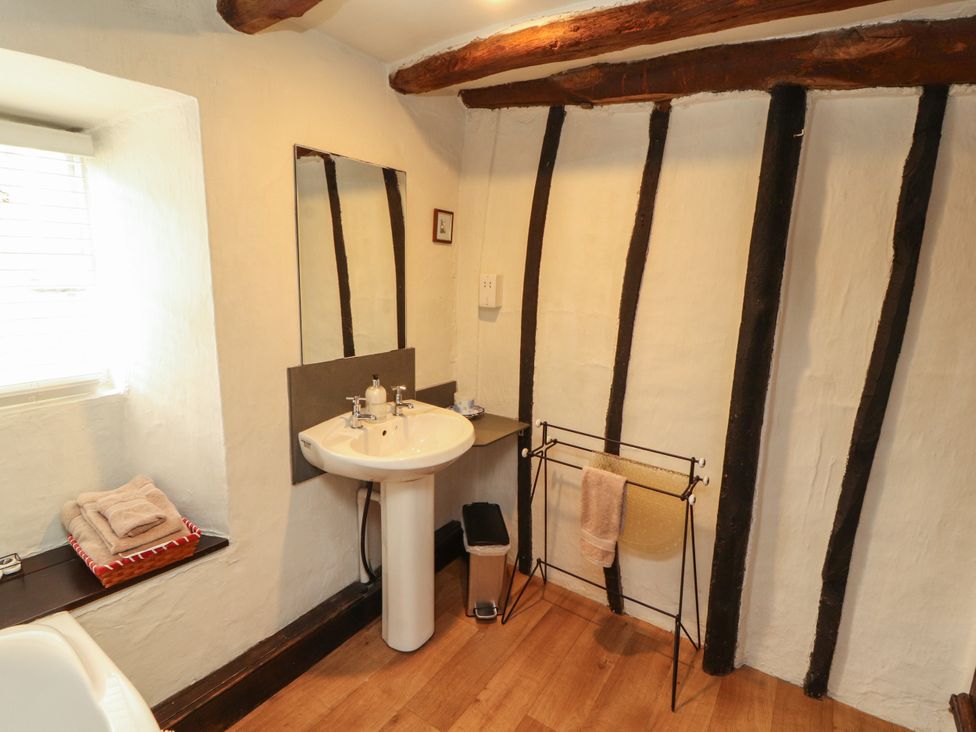 A bathroom with a sink and mirror at Mill Cottage in Garnett Bridge