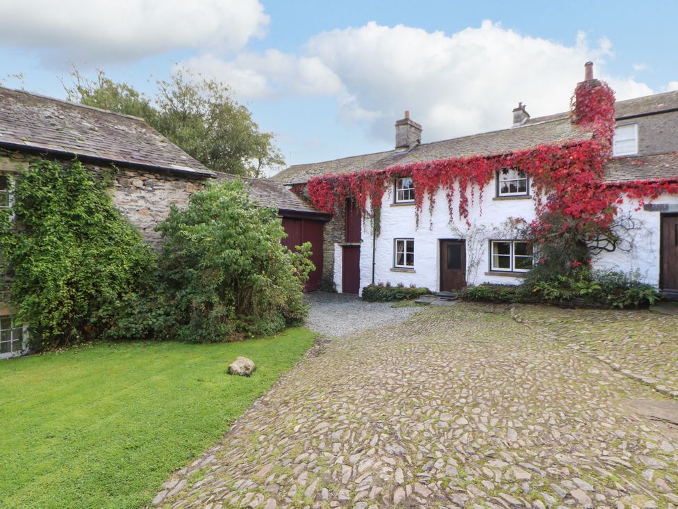 An outdoor view of a cottage with ivy at Mill Cottage in Garnett Bridge