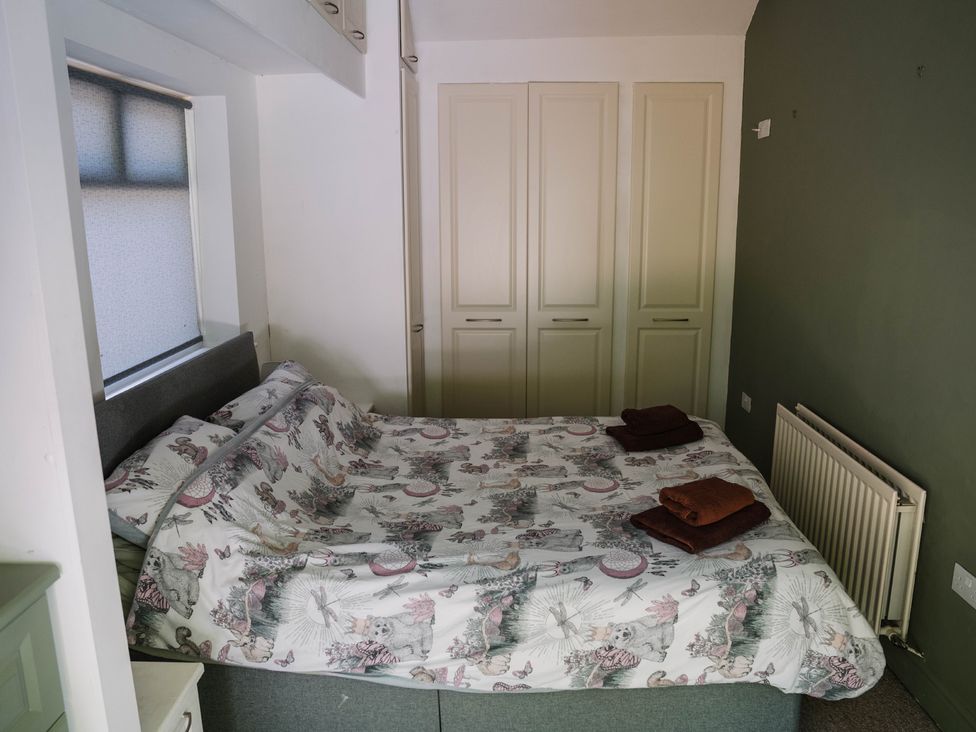 A bedroom with a bed and cabinets at Carwinley Mill House Cottage Longtown