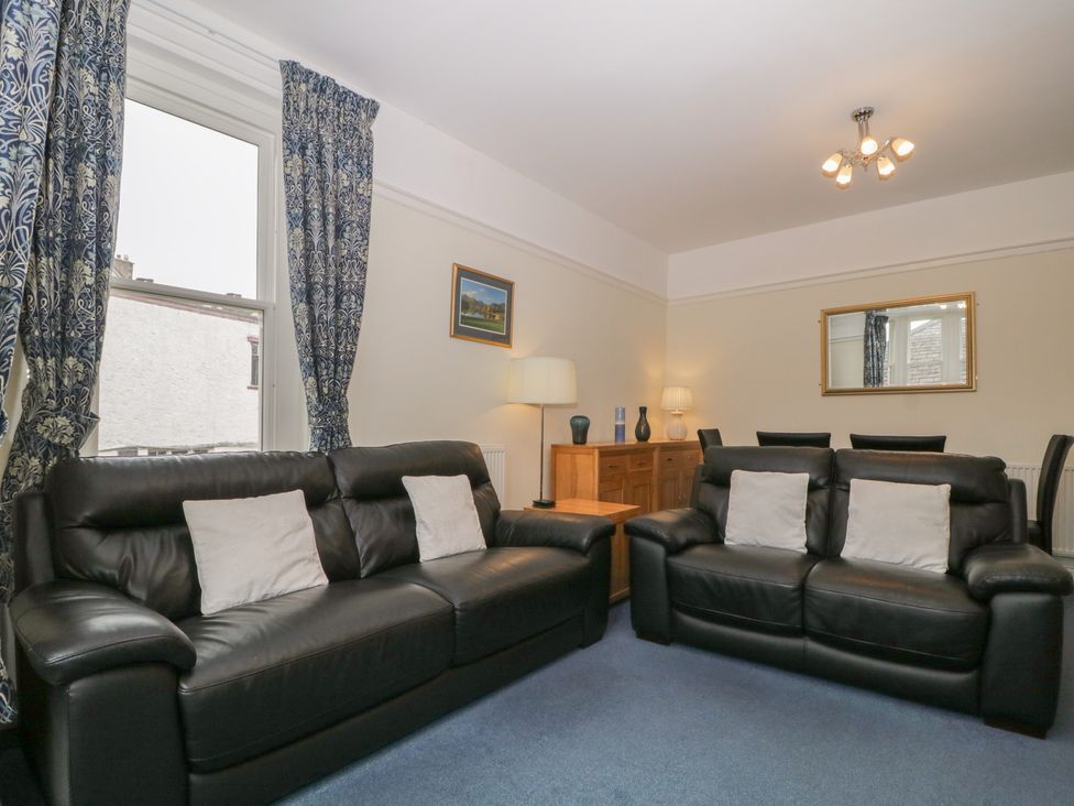 A living room with sofas and a lamp at Amba in Keswick