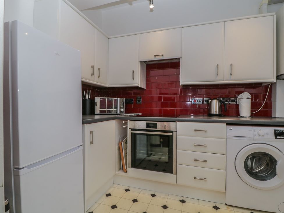 A kitchen with appliances and cabinetry at Amba in Keswick