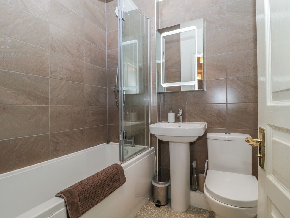 A bathroom with a bathtub and shower at Amba in Keswick