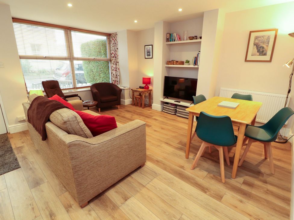 A living room with a sofa and television at Archers in Keswick