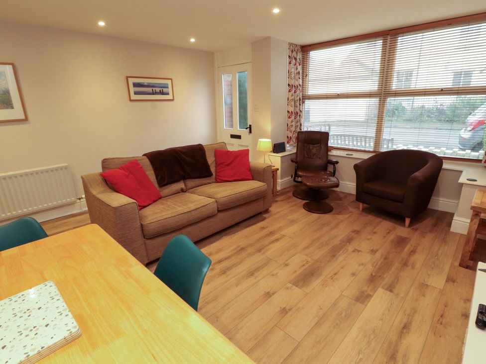 A living room with a sofa and armchair at Archers in Keswick