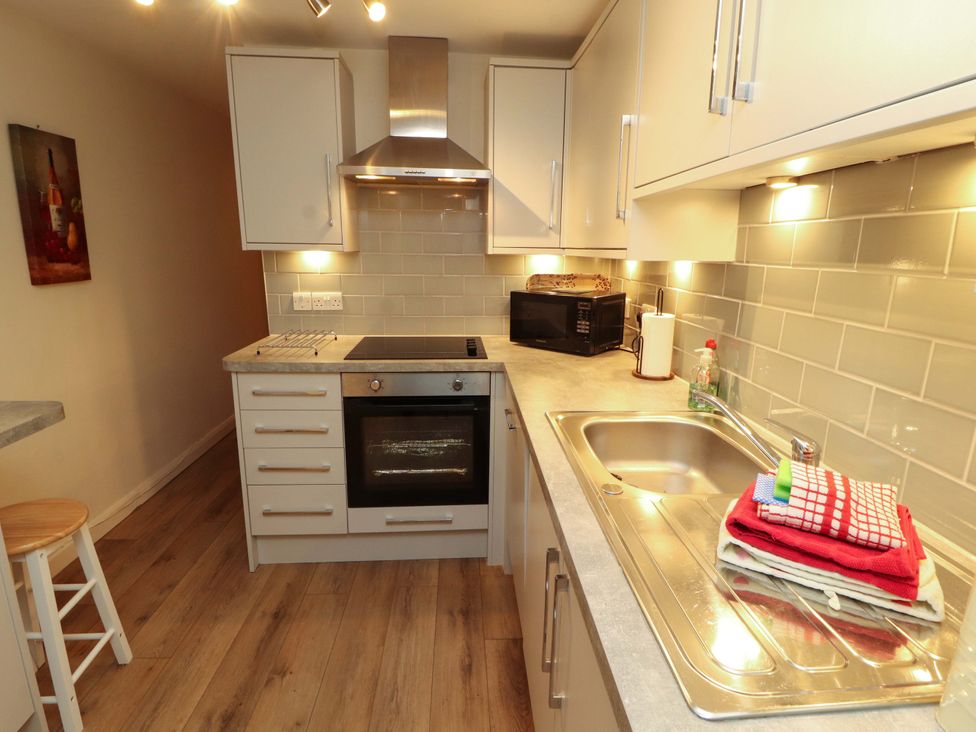 A kitchen with stove and sink at Archers in Keswick