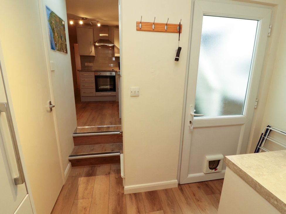 A kitchen with steps leading to a lower area at Archers in Keswick