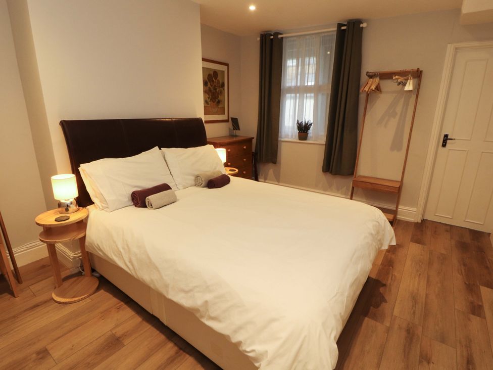 A bedroom with a bed and nightstand at Archers in Keswick