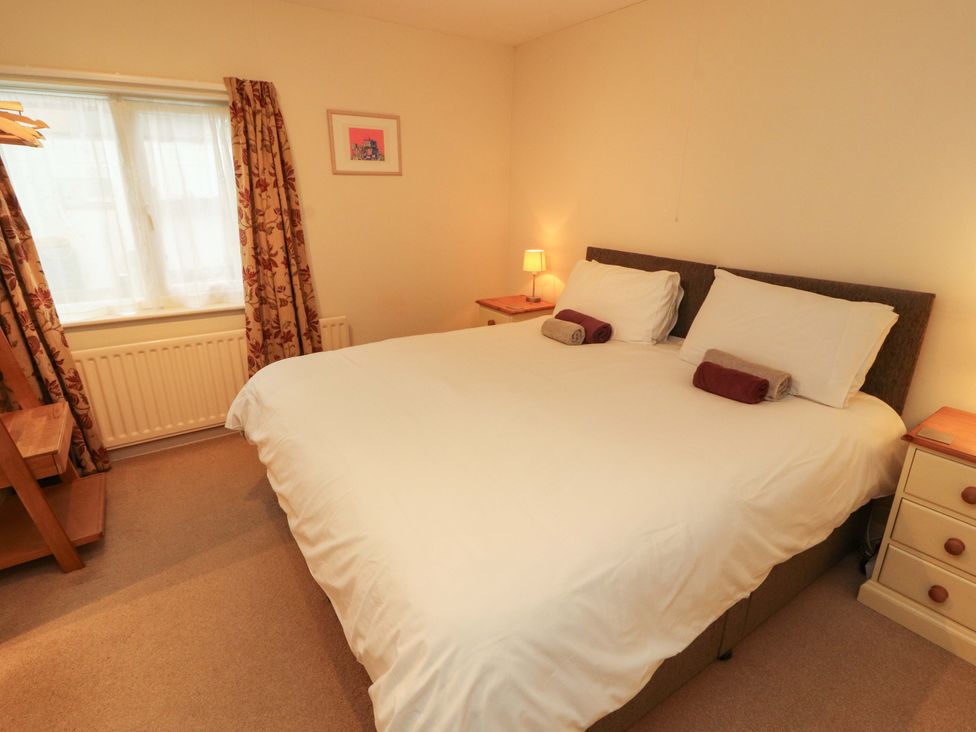 A bedroom with a bed and lamp at Archers in Keswick