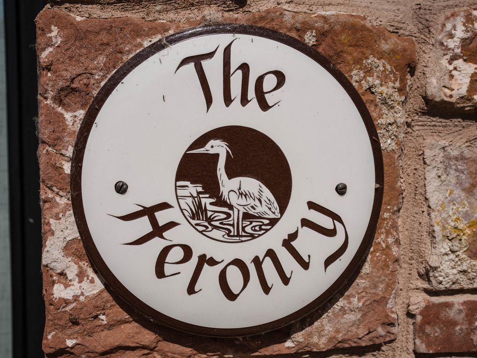A sign with The Heronry name and an image of a heron at The Heronry in Longtown