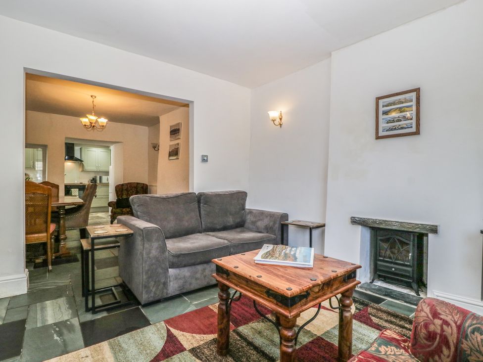A living room with a sofa and coffee table at Fountain Cottage in Keswick