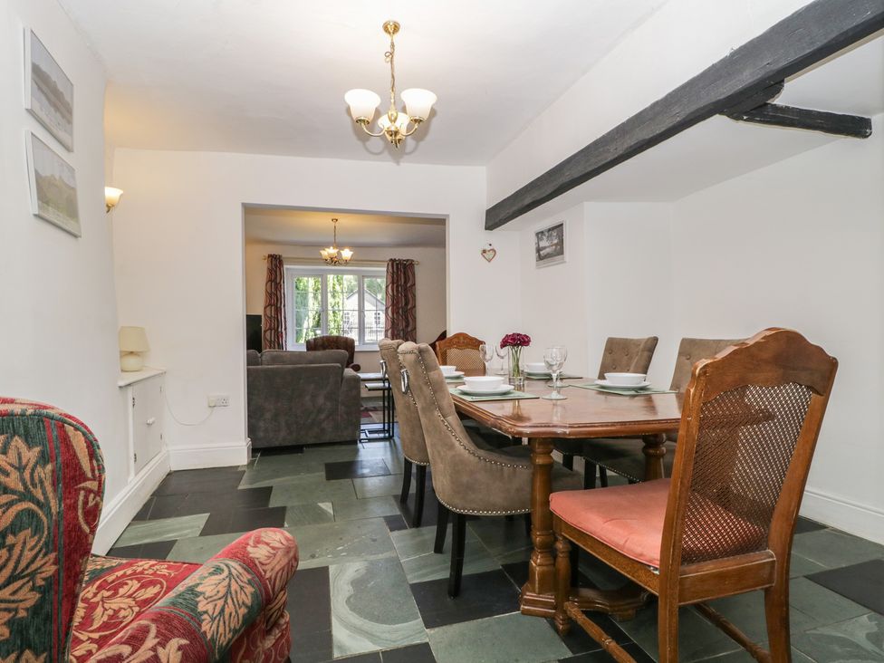 A dining room with a table and chairs at Fountain Cottage in Keswick