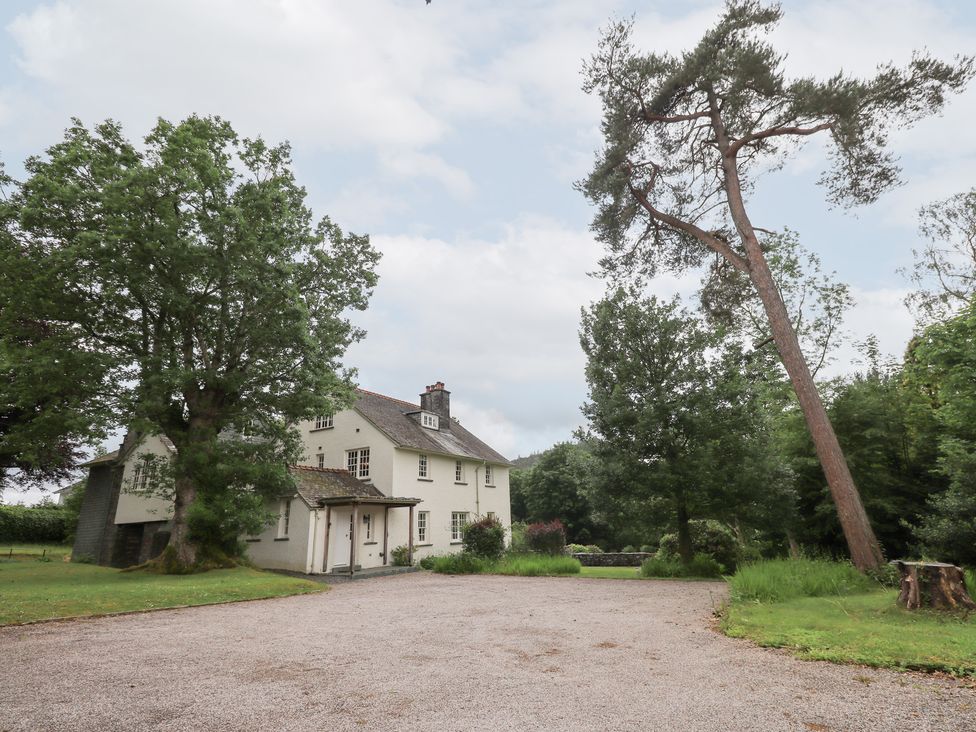 A house surrounded by trees and a driveway at Little Ellers in Portinscale near Keswick