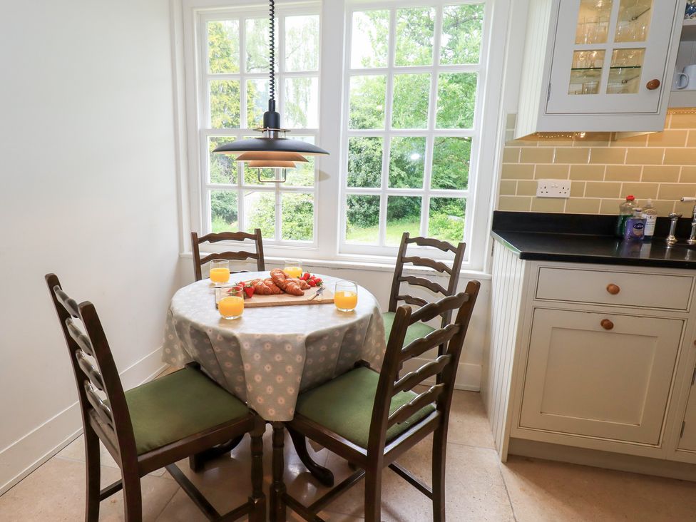 A kitchen with a table and chairs at Little Ellers Portinscale near Keswick