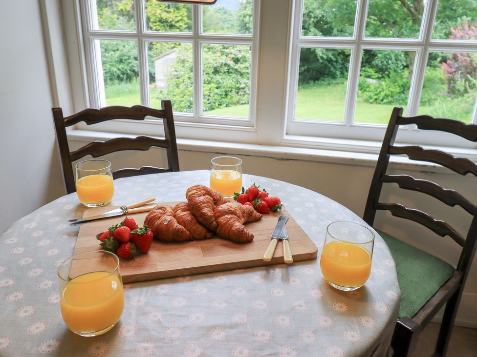 A dining room table with croissants and glasses of orange juice at Little Ellers Portinscale near Keswick