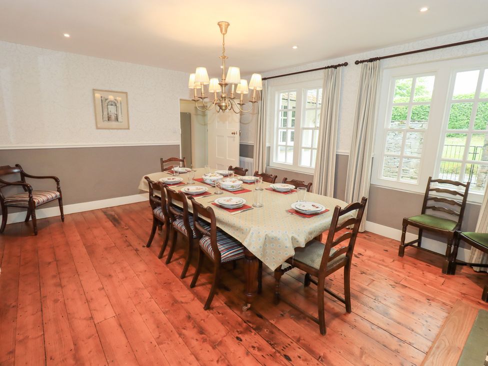 A dining room with a table set for dinner at Little Ellers in Portinscale near Keswick