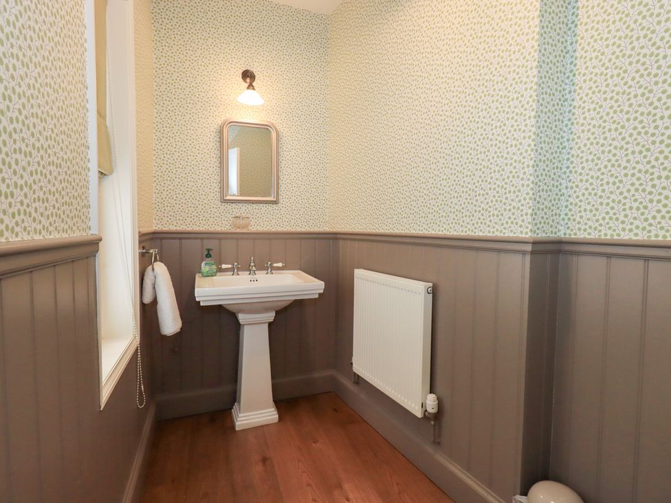 A bathroom with a sink and a mirror at Little Ellers in Portinscale near Keswick