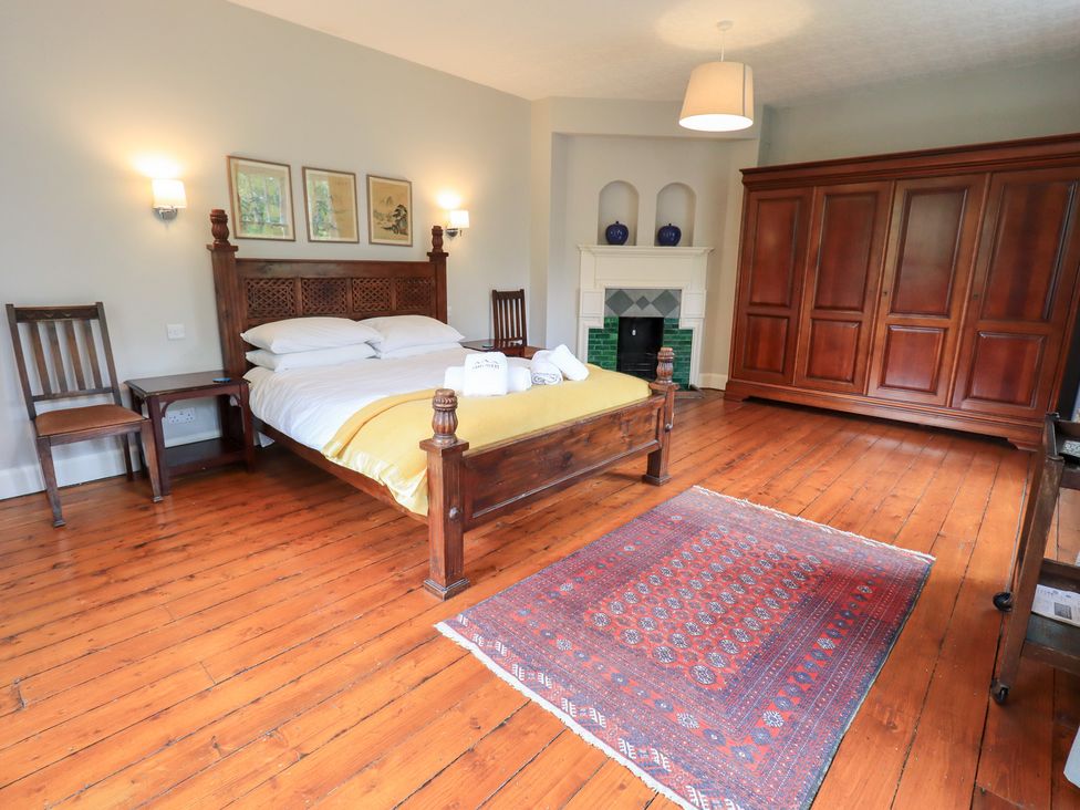 A bedroom with a bed and furniture at Little Ellers in Portinscale near Keswick