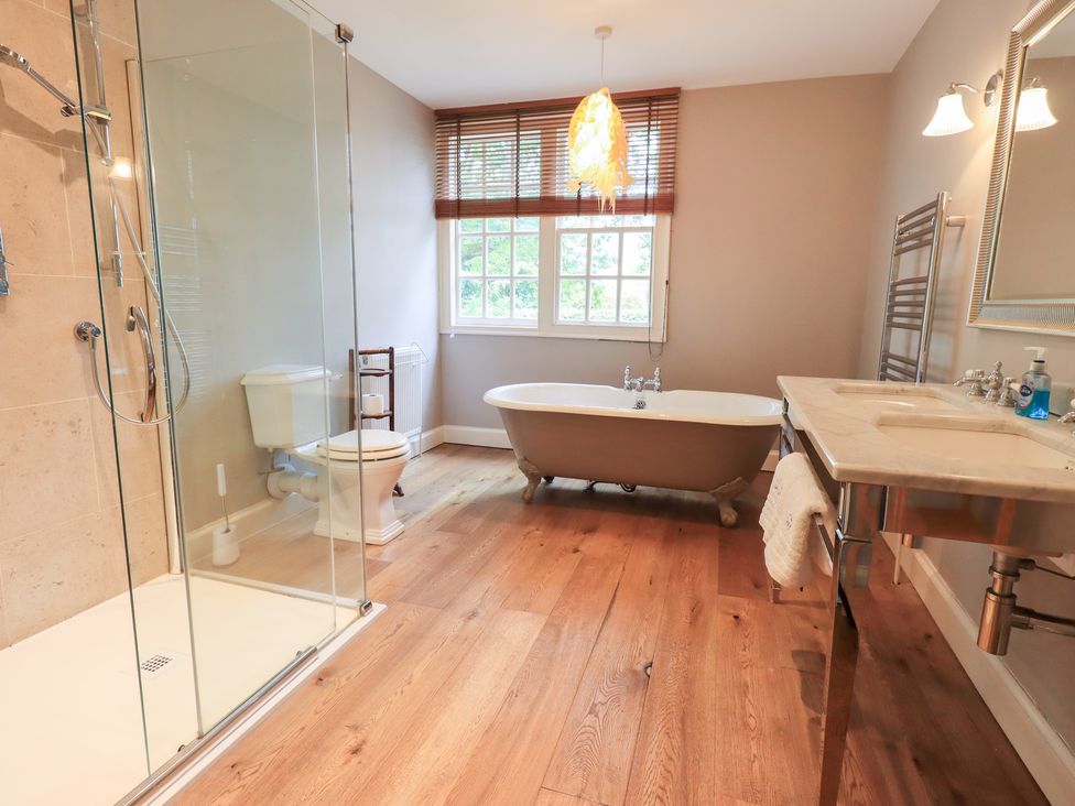 A bathroom with a shower and bathtub at Little Ellers in Portinscale near Keswick