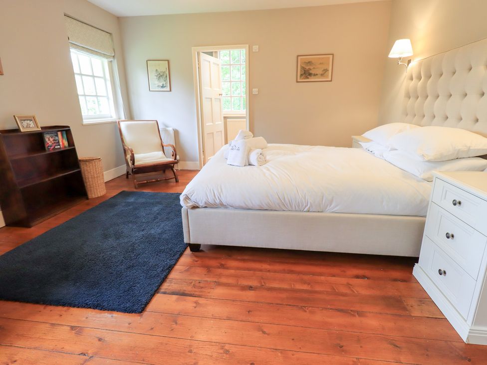 A bedroom with a bed and nightstand at Little Ellers in Portinscale near Keswick