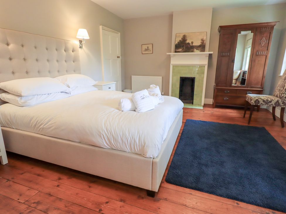 A bedroom with a bed and dressing table at Little Ellers Portinscale near Keswick