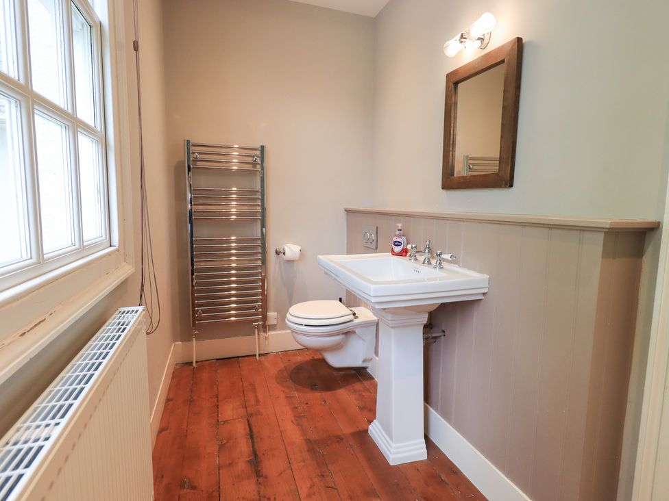 A bathroom with a sink toilet and towel rail at Little Ellers in Portinscale near Keswick