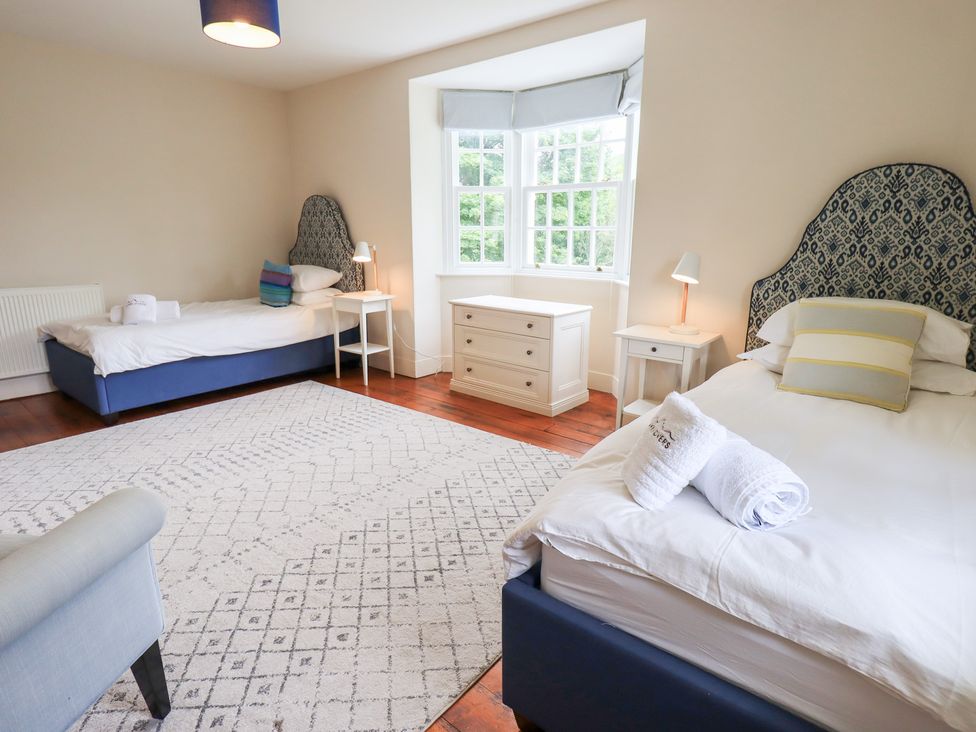 A bedroom with two beds and a window at Little Ellers in Portinscale near Keswick