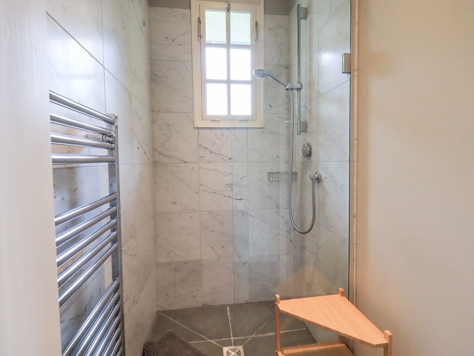 A shower area with a towel rail and a window at Little Ellers Portinscale near Keswick