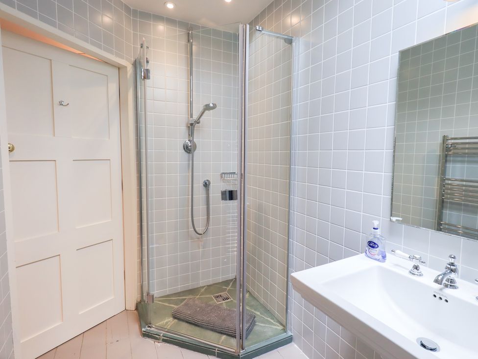 A bathroom with a shower and sink at Little Ellers in Portinscale near Keswick