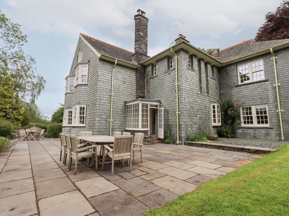 An outdoor patio with a table and chairs at Little Ellers in Portinscale near Keswick