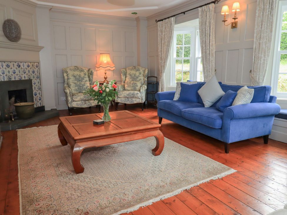 A living room with armchairs, a sofa, and a coffee table at Little Ellers Portinscale near Keswick