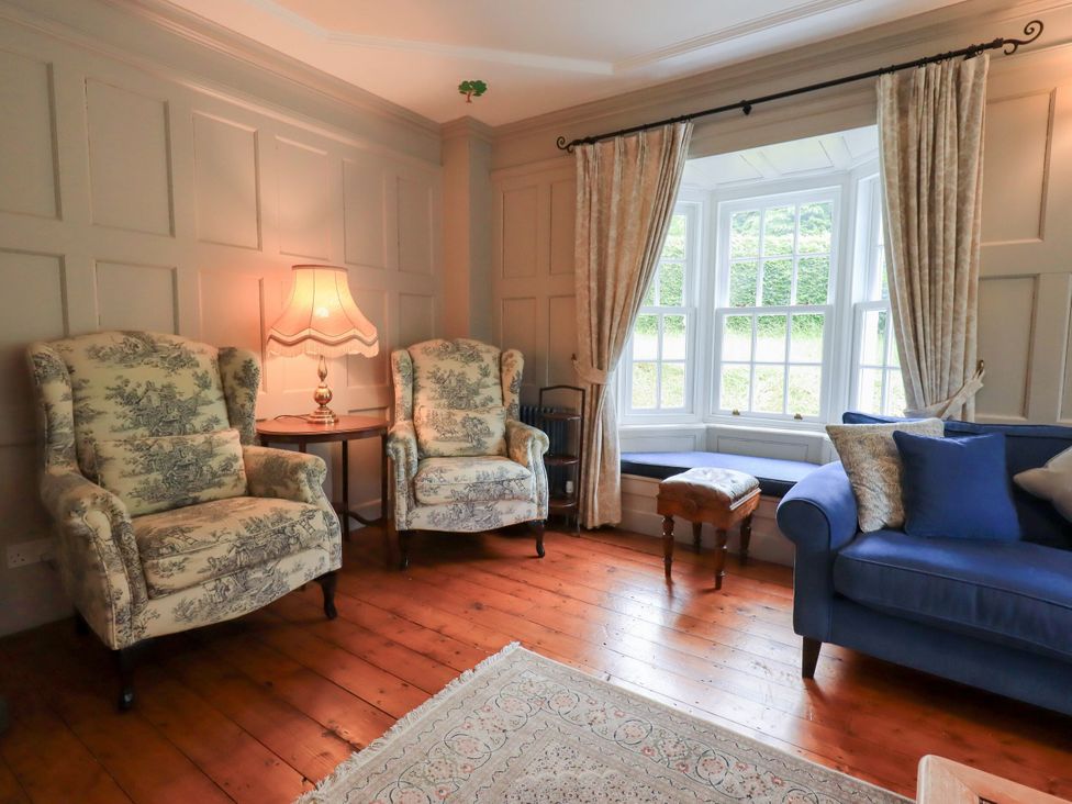 A living room with seating and a lamp at Little Ellers Portinscale near Keswick