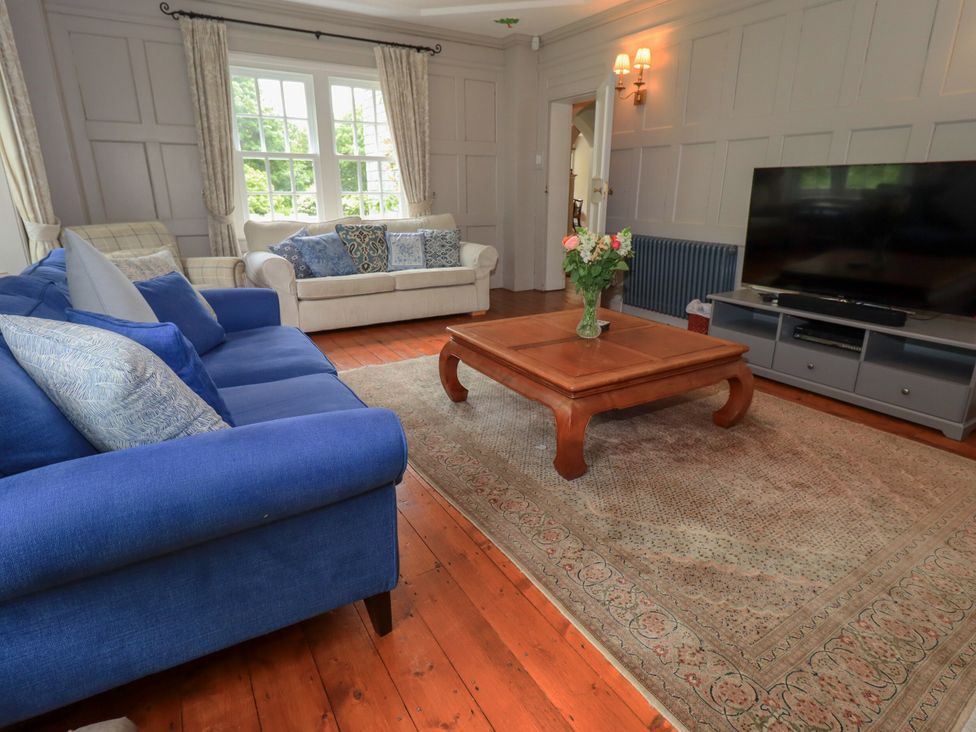 A living room with a blue sofa and coffee table at Little Ellers in Portinscale near Keswick