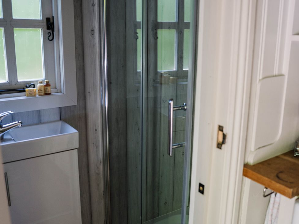 A bathroom with a shower and sink at The Snug in Longtown