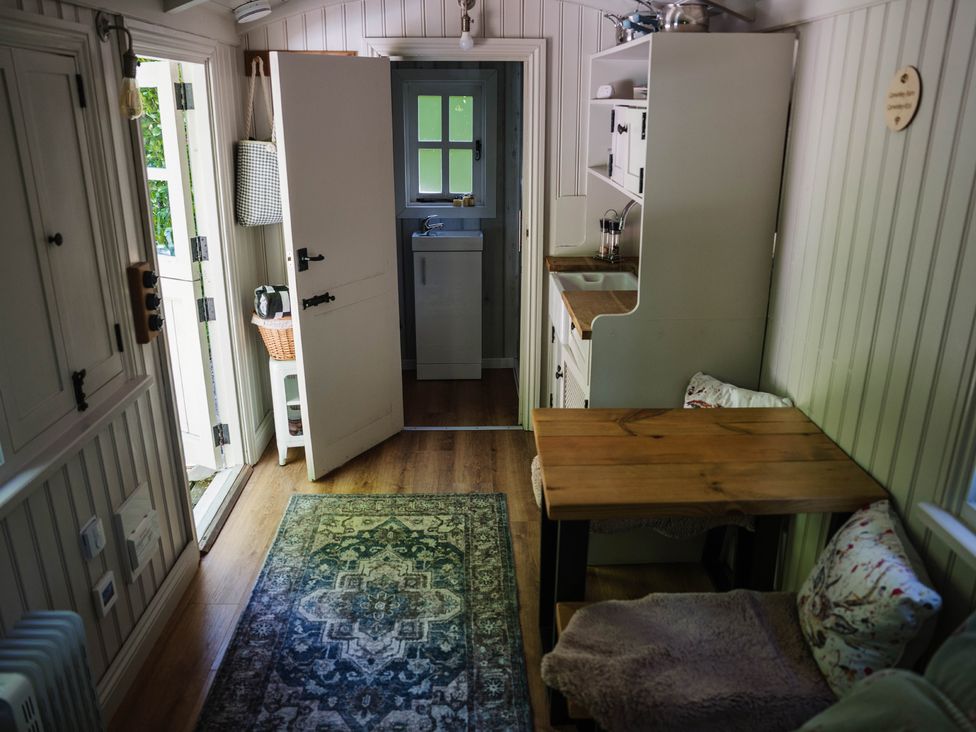 A kitchen with a table and chairs at The Snug in Longtown