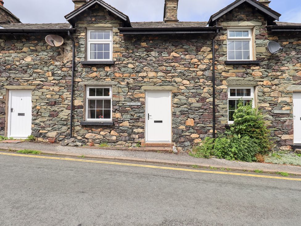 A stone cottage exterior with front doors and windows at Millcroft Glenridding