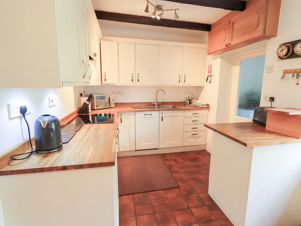 A kitchen with cabinets and appliances at Millcroft in Glenridding