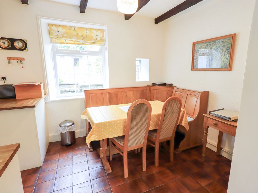 A kitchen with a dining table and chairs at Millcroft in Glenridding