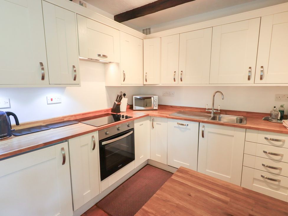 A kitchen with cabinets and a countertop at Millcroft in Glenridding