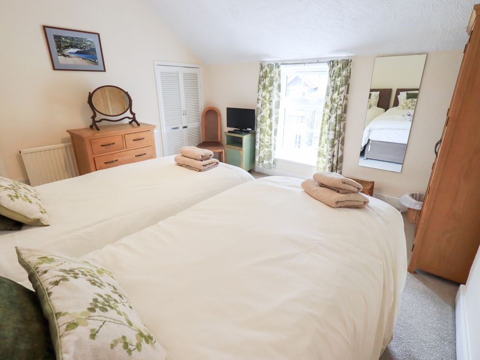 A bedroom with two twin beds and a dresser at Millcroft in Glenridding
