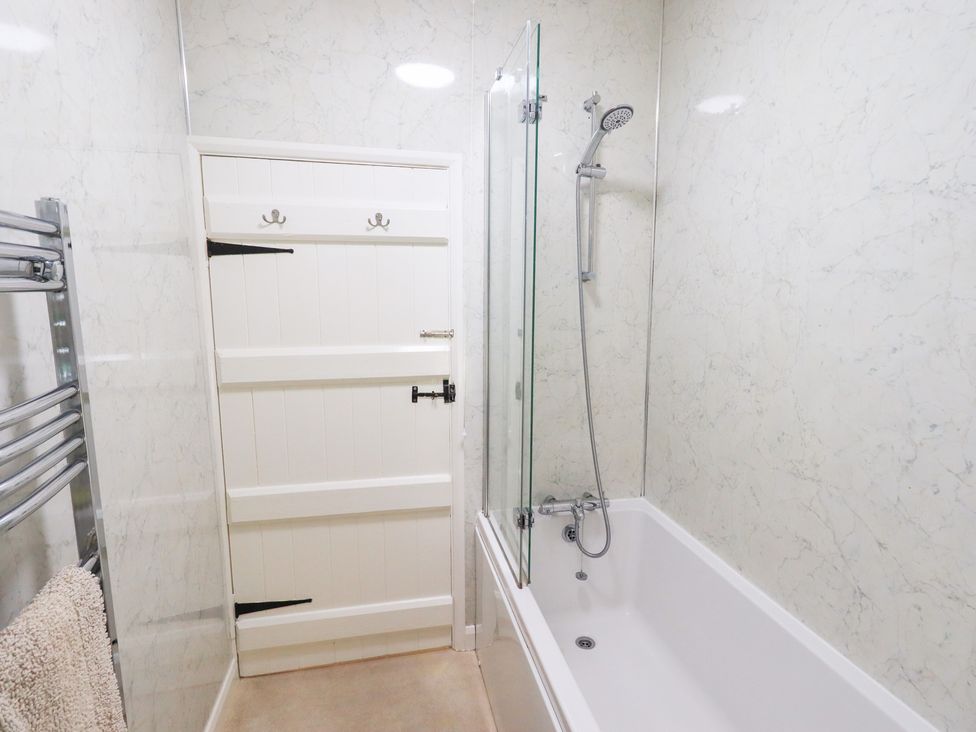 A bathroom with a bathtub and shower at Millcroft in Glenridding