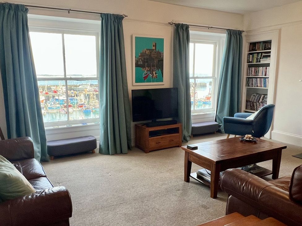 A living room with a television and coffee table at Westcliff in Newlyn