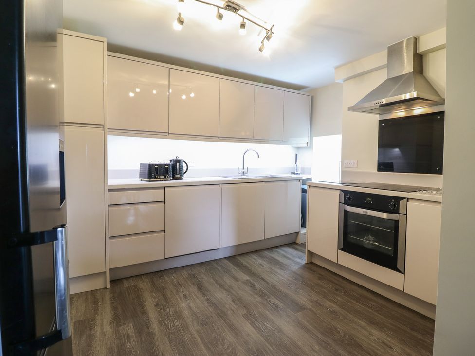 A kitchen with modern cabinets and appliances at Cefn Uchaf Cottage in Llanbedr