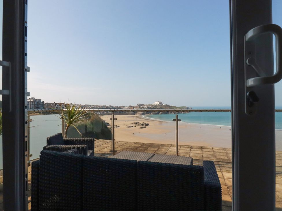 An outdoor area with chairs and a view of the beach at The View in Newquay